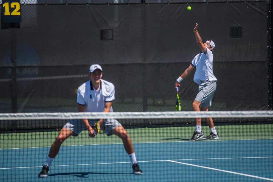 Iowa's Nikita Snezhko hits a serve during a men's tennis match between Iowa and Michigan at the HTRC on Sunday, April 21, 2019. The Hawkeyes, celebrating senior day, defeated the Wolverines, 4-1.