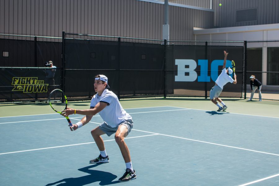 Iowa's Joe Tyler hits a serve during a men's tennis match between Iowa and Michigan at the HTRC on Sunday, April 21, 2019. The Hawkeyes, celebrating senior day, defeated the Wolverines, 4-1.