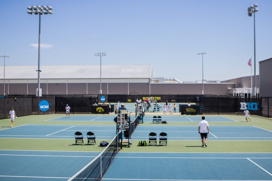 Singles play is underway during a men's tennis match between Iowa and Michigan at the HTRC on Sunday, April 21, 2019. The Hawkeyes, celebrating senior day, defeated the Wolverines, 4-1.