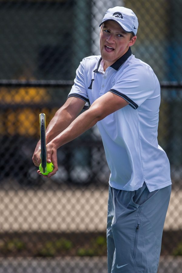 Iowa's Joe Tyler prepares to serve during a men's tennis match between Iowa and Michigan at the HTRC on Sunday, April 21, 2019. The Hawkeyes, celebrating senior day, defeated the Wolverines, 4-1.