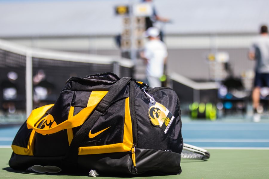 A tennis bag rests courtside during a men's tennis match between Iowa and Michigan at the HTRC on Sunday, April 21, 2019. The Hawkeyes, celebrating senior day, defeated the Wolverines, 4-1.