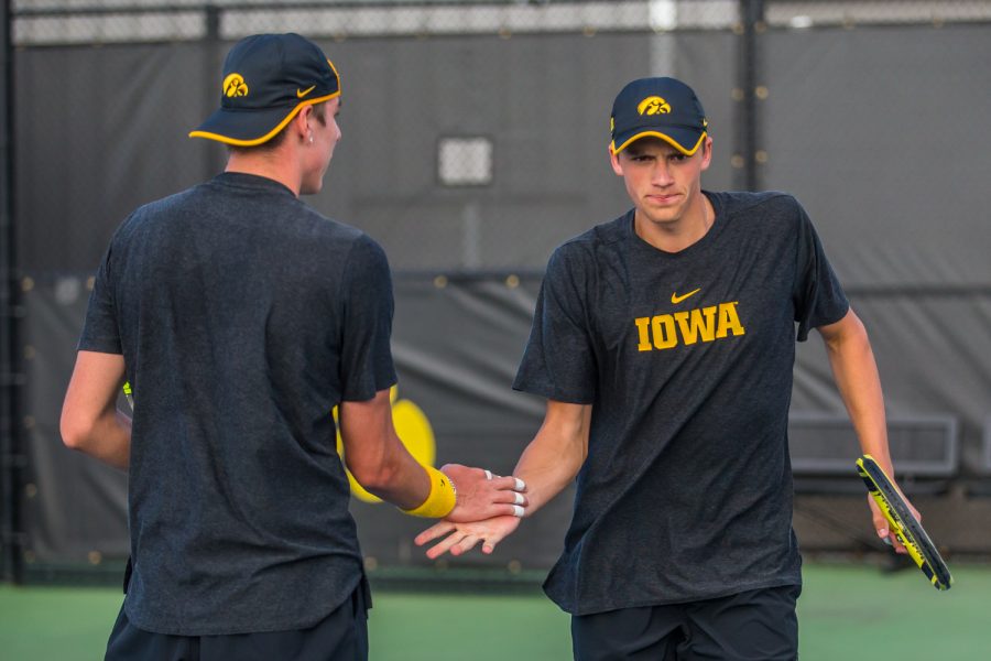 Iowa's Joe Tyler (right) high-fives partner Nikita Snezhko during a men's tennis match between Iowa and Illinois State at the HTRC on Sunday, April 21, 2019. The Hawkeyes defeated the Redbirds, 6-1.