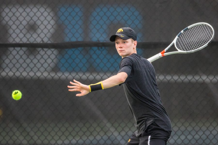 Iowas Jason Kerst hits a forehand during a mens tennis match between Iowa and Illinois State at the HTRC on Sunday, April 21, 2019. The Hawkeyes defeated the Redbirds, 6-1.