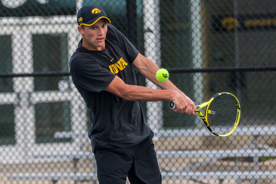 Iowa's Joe Tyler hits a backhand during a men's tennis match between Iowa and Illinois State at the HTRC on Sunday, April 21, 2019. The Hawkeyes defeated the Redbirds, 6-1.