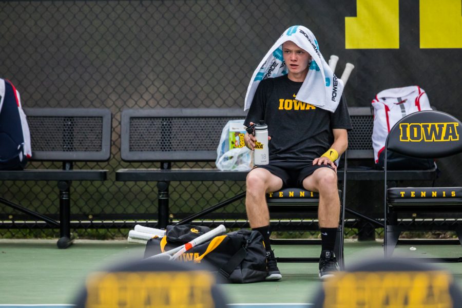 Iowa's Jason Kerst rests on a changeover during a men's tennis match between Iowa and Illinois State at the HTRC on Sunday, April 21, 2019. The Hawkeyes defeated the Redbirds, 6-1.