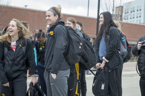 Teammates laugh as others depart the bus at the Transit Center on April 2, 2019. 