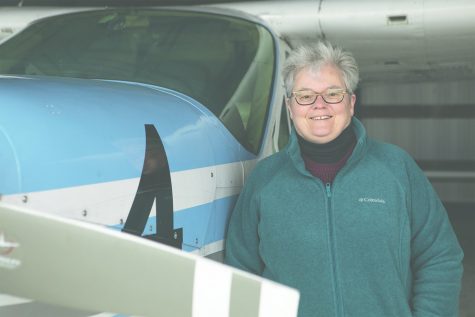 University of Iowa professor Minetta Gardinier poses for a picture next to the 1978 Cessna Cardinal at the Iowa City Municipal Airport on Wednesday, April 10. Gardinier races the Cessna in the United States and Canada. 
