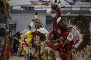 Dancers perform in the grand entrance during the 25th annual University of Iowa Powwow in the Fieldhouse on April 20, 2019. Hosted by the Native American Student Association, participants could buy traditional food and clothing, and sign up to perform traditional song and dance.