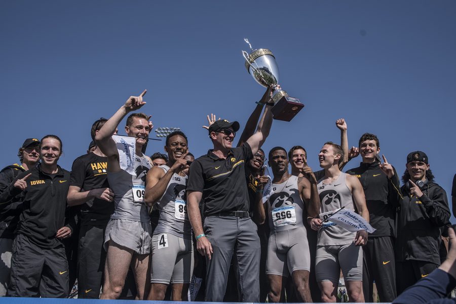 The Iowa mens track and field team stand on the awards stage after placing first for the Hy-vee Cup at the 2018 Drake Relays at Drake Stadium in Des Moines, Iowa on Saturday, April 28, 2018. 