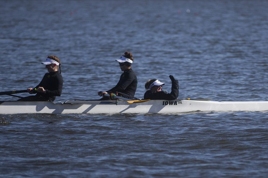 An+Iowa+coxswain+waves+to+the+Iowa+tents+as+her+boat+heads+back+after+a+race+in+the+first+session+of+a+womens+rowing+meet+on+Lake+MacBride+on+Saturday+April+13%2C+2019.+Iowa+won+3+out+of+12+races+with+the+varsity+8+crew+winning+both+races+for+the+day.