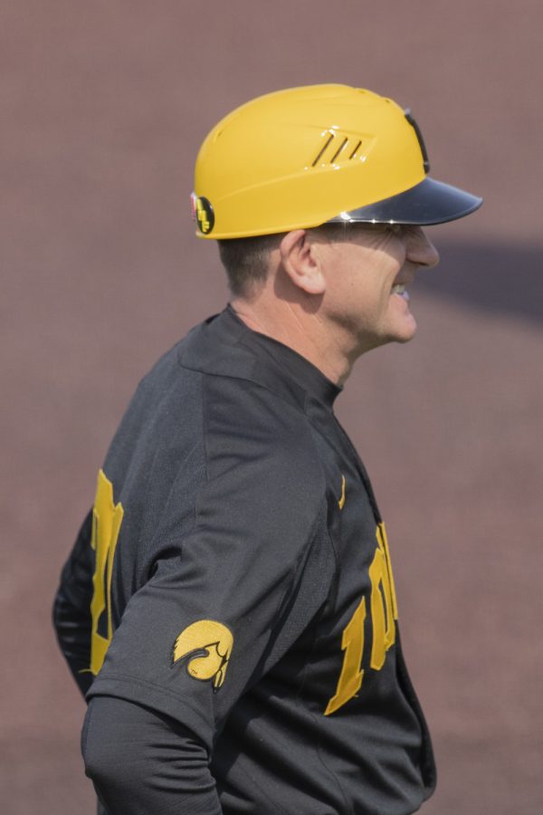 Iowa Head Coach Rick Heller smiles after overhearing fans talking about him in the stands during the afternoon Iowa vs Rutgers game at Duane Banks Field on Saturday, April 7, 2019. The Hawkeyes defeated the Scarlet Knights 9-5. 