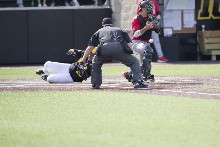 Rutgers catcher drops the ball as Iowa infielder Izaya Fullard slides into home plate, scoring one of four runs in the sixth inning of the afternoon Iowa vs Rutgers game at Duane Banks Field on Saturday, April 7, 2019. The Hawkeyes defeated the Scarlet Knights 9-5. 