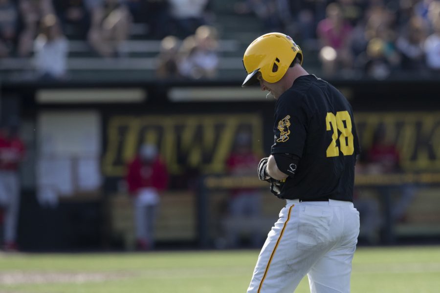 Iowa fielder Chris Whelan spits on his way back to the dugout after grounding out in the bottom of the eighth during the afternoon Iowa vs Rutgers game at Duane Banks Field on Saturday, April 7, 2019. The Hawkeyes defeated the Scarlet Knights 9-5.