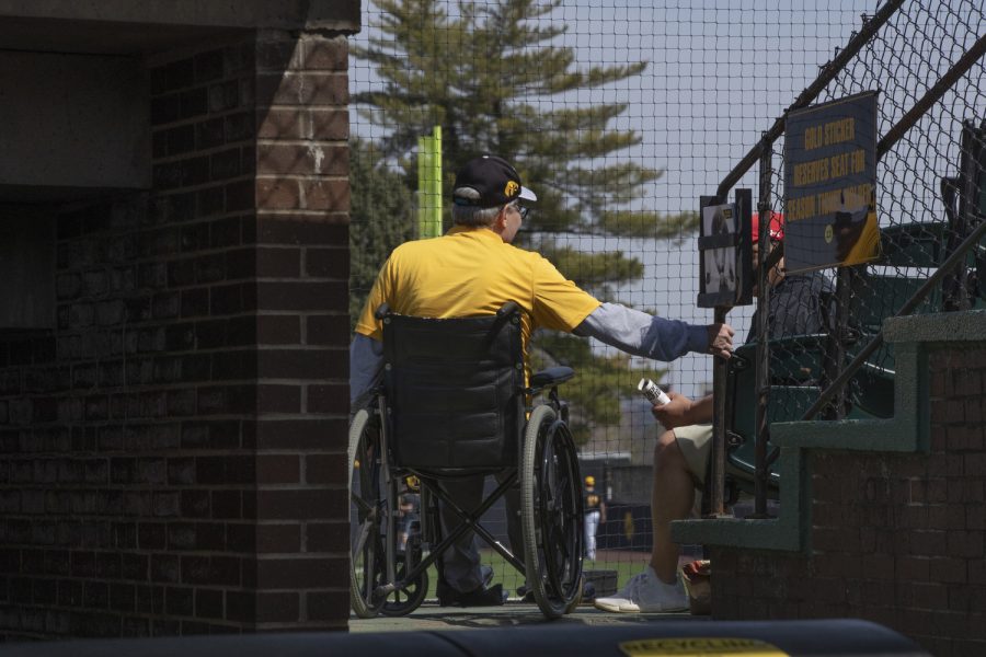 An Iowa fan has a conversation during the afternoon Iowa vs Rutgers game at Duane Banks Field on Saturday, April 7, 2019. The Hawkeyes defeated the Scarlet Knights 9-5.