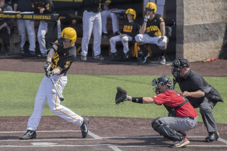 Iowa fielder Connor McCaffery hits the ball during the second inning of the afternoon Iowa vs Rutgers game at Duane Banks Field on Saturday, April 7, 2019. Rutgers caught the ball to get McCaffery out on the play. The Hawkeyes defeated the Scarlet Knights 9-5. 