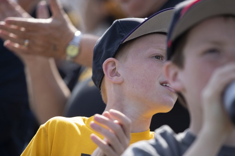 A young Iowa fan leans to watch Iowa fielder Tanner Wetrich round the bases after hitting a home run during the second inning of the afternoon Iowa vs Rutgers game at Duane Banks Field on Saturday, April 7, 2019. The Hawkeyes defeated the Scarlet Knights 9-5.