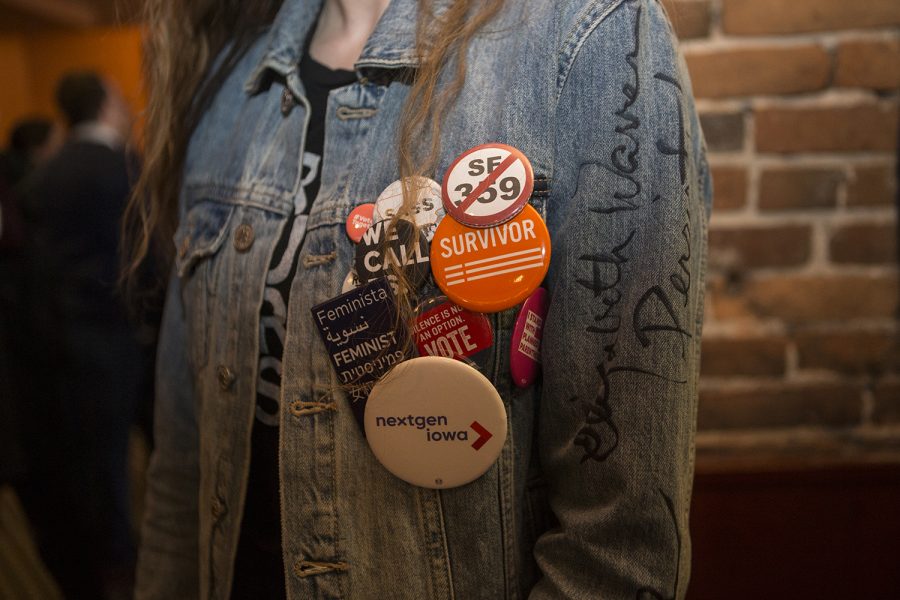 Freshman Shayna Jaskolka poses with her jaket during Pete Buttigieg's visit to Airliner in Iowa City on March 4, 2019. Buttigieg, Mayor of South Bend, Indiana, has declared a presidential exploratory committee, joining a slew of democrats who may be running. (Katie Goodale /The Daily Iowan)