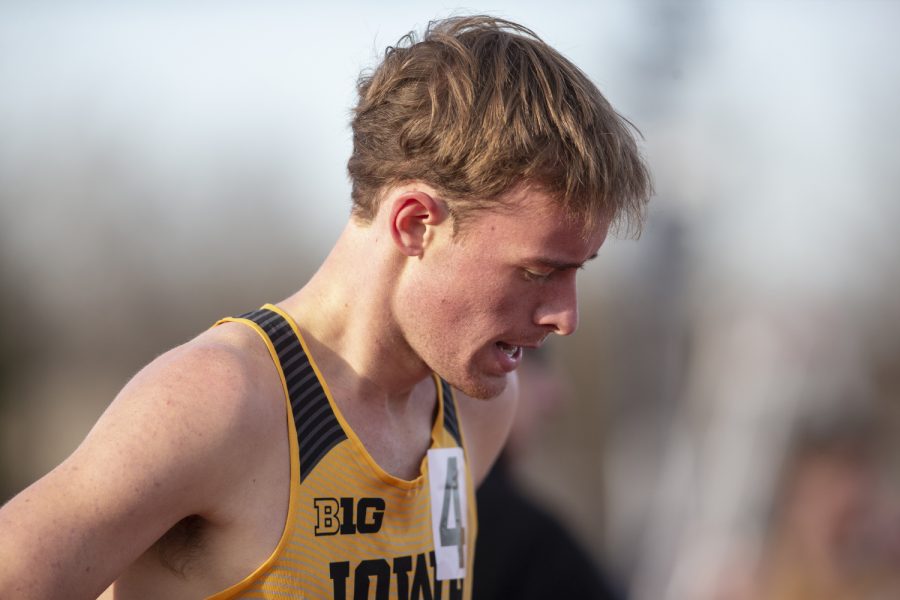 Iowa distance runner Jeff Roberts recovers after the 1500m run at the Musco Twilight Invitational at the Cretzmeyer Track on Saturday, April 13, 2019. Roberts finished sixth with a time of 3:59:65. The Hawkeyes won 10 events during the meet. The Iowa women ranked first with 183 points, and the men ranked fifth 76 points.