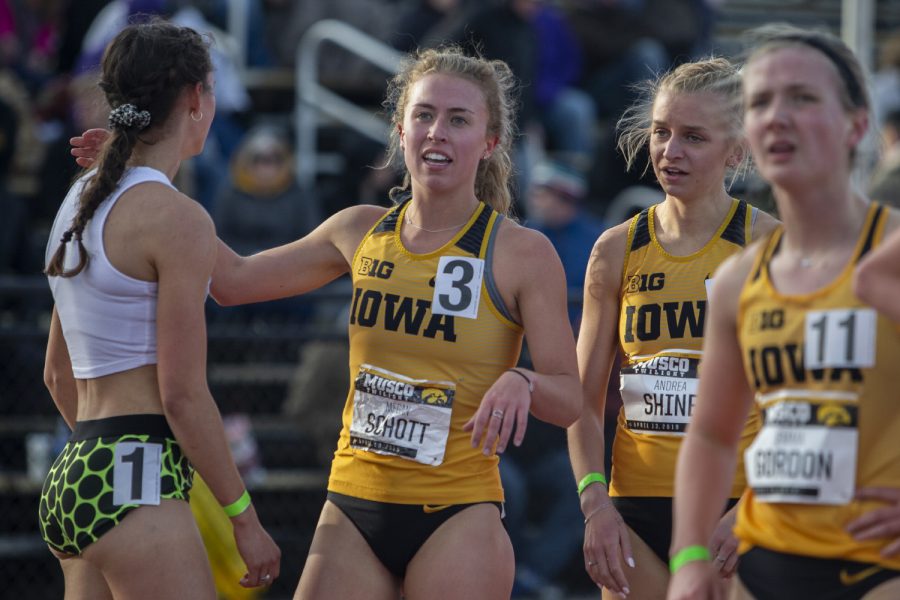 Iowa distance runner Megan Schott congratulates competitors and looks up at the scoreboard after the 1500m run at the Musco Twilight Invitational at the Cretzmeyer Track on Saturday, April 13, 2019. Schott won the race with a time of 4:33:68. The Hawkeyes won 10 events during the meet. The Iowa women ranked first with 183 points, and the men ranked fifth 76 points.