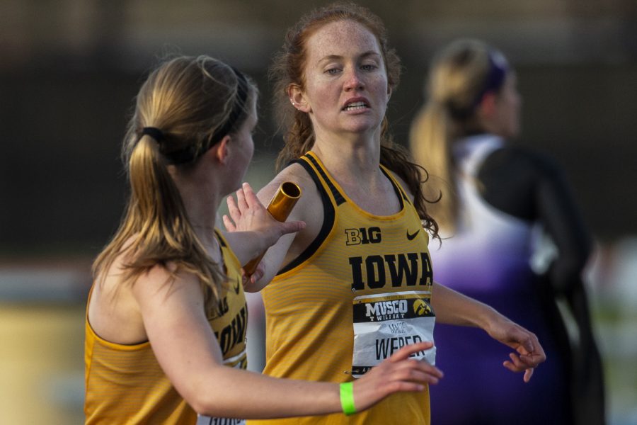 Iowa distance runner Macie Weber hands off to teammate Emma Gordon during the 4x400m relay at the Musco Twilight Invitational at the Cretzmeyer Track on Saturday, April 13, 2019. The relay team placed sixth with a time of 4:22:!4. The Hawkeyes won 10 events during the meet. The Iowa women ranked first with 183 points, and the men ranked fifth 76 points.