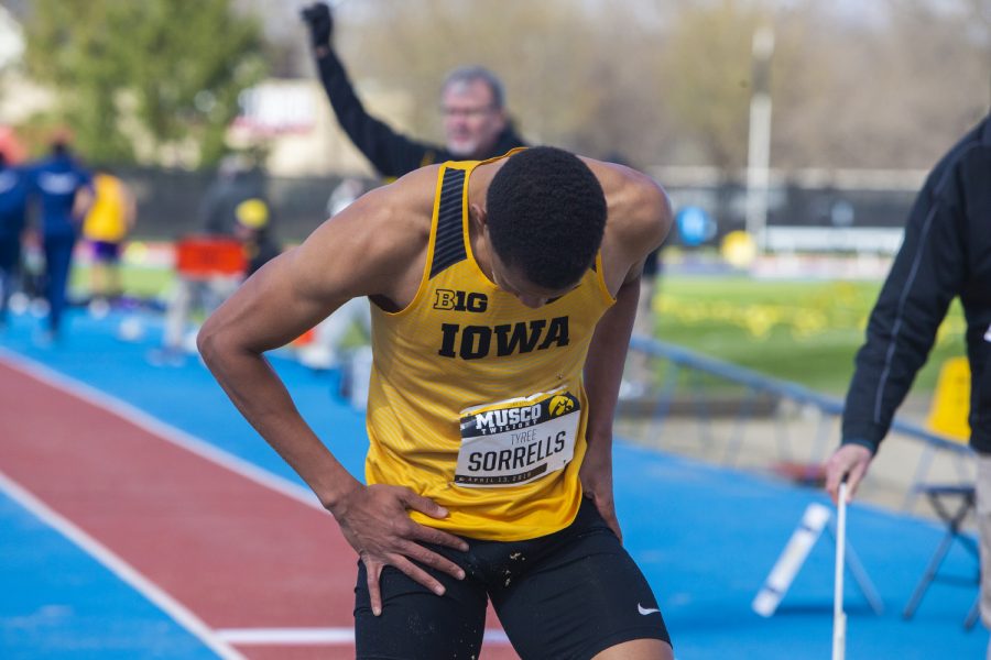 Iowa long jumper Tyree Sorrells shakes sand off his uniform at the Musco Twilight Invitational at the Cretzmeyer Track on Saturday, April 13, 2019. Sorrells placed eighth in the long jump with a distance of 6.62m. The Hawkeyes won 10 events during the meet. The Iowa women ranked first with 183 points, and the men ranked fifth 76 points.