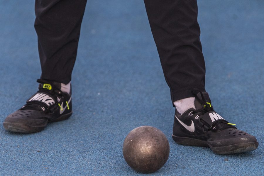 A shot put sits at a throwers feet at the Musco Twilight Invitational at the Cretzmeyer Track on Saturday, April 13, 2019. The Hawkeyes won 10 events during the meet. The Iowa women ranked first with 183 points, and the men ranked fifth 76 points.