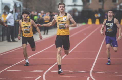 Iowa’s Chris Douglas finishes first in the 200 meters during the 19th-annual Musco Twilight meet at the Cretzmeyer Track on April 12, 2018.