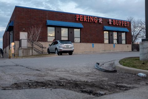 A large pothole is seen outside of Peking Buffet in Coralville on Monday, April 1. As spring moves forward, Iowa City and Coralville will continue to fill potholes and other road disturbances. 