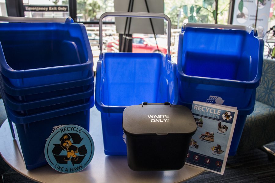 New recycling bins are seen in the UI Office of Sustainability on July 2, 2018. The Public Space Recycling Bin grant from Coca Cola North America and the Keep America Beautiful foundation provided the office with 500 new recycling bins to be placed around campus. (Katina Zentz/The Daily Iowan).