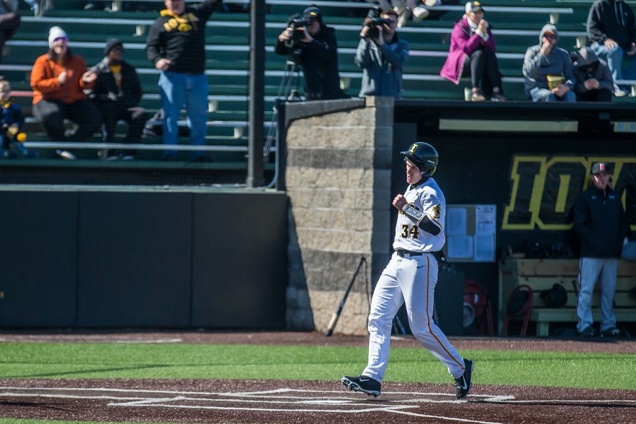 Iowa catcher Austin Martin scores during a baseball game between Iowa and Cal-State Northridge at Duane Banks Field on Saturday, March 16, 2019. The Hawkeyes dropped their home opener to the Matadors, 8-5. 