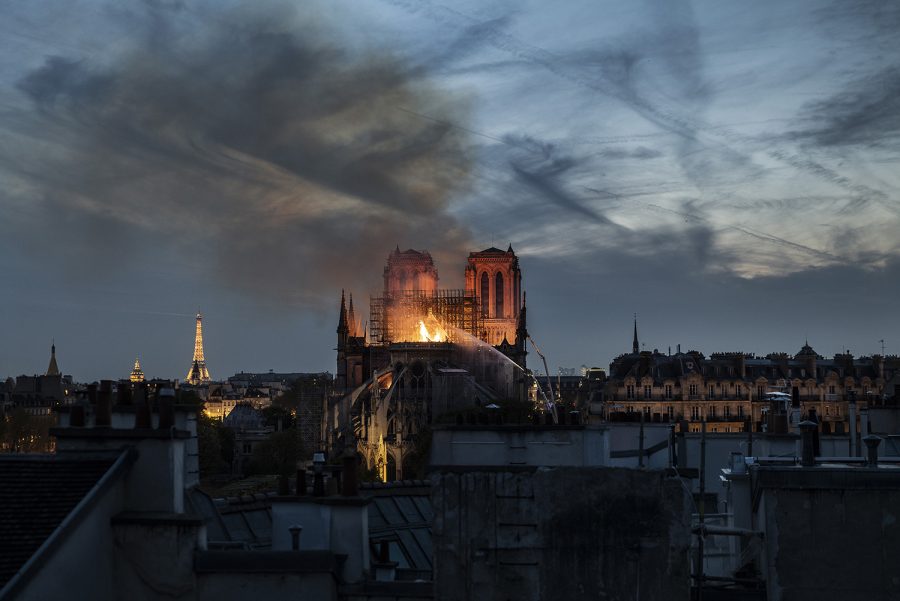 Smoke and flames rise from Notre-Dame Cathedral on April 15, 2019 in Paris, France. A fire broke out on Monday afternoon and quickly spread across the building, collapsing the spire. The cause is yet unknown but officials said it was possibly linked to ongoing renovation work. 
