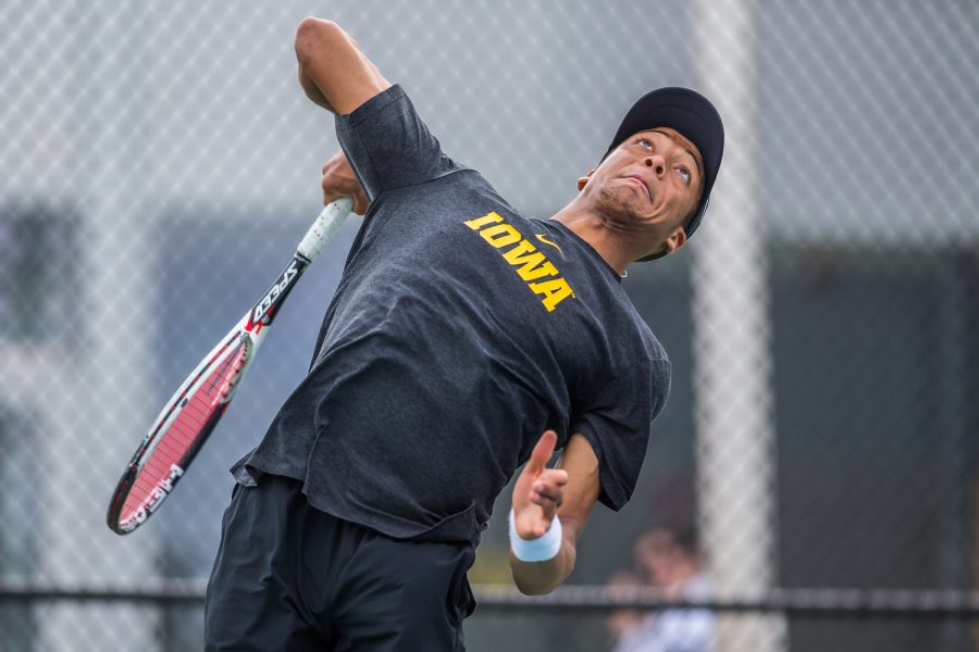 Iowas Oliver Okonkwo hits a serve during a mens tennis match between Iowa and Ohio State at the HTRC on Sunday, April 7, 2019. The Buckeyes defeated the Hawkeyes, 4-1. 