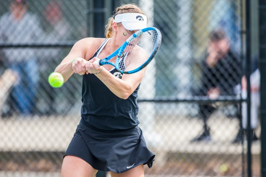 Iowa's Ashleigh Jacobs hits a backhand during a women's tennis match between Iowa and Rutgers at the HTRC on Friday, April 5, 2019. The Hawkeyes defeated the Scarlet Knights, 6-1.