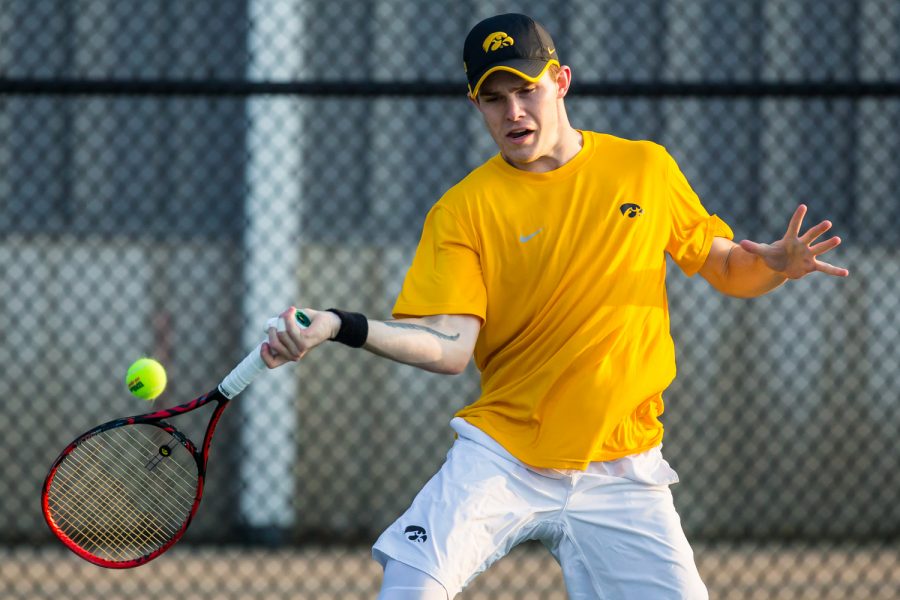 Iowas Jonas Larsen hits a forehand during a mens tennis match between Iowa and Penn State at the HTRC on Friday, April 5, 2019. The Hawkeyes defeated the Nittany Lions, 4-3.