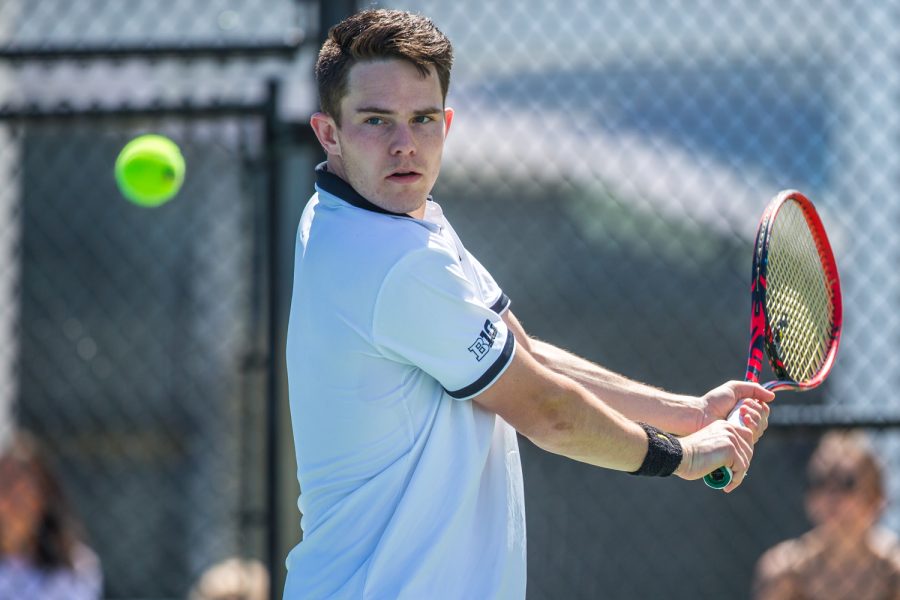 Iowa's Jonas Larsen hits a backhand during a men's tennis match between Iowa and Michigan at the HTRC on Sunday, April 21, 2019. The Hawkeyes, celebrating senior day, defeated the Wolverines, 4-1.