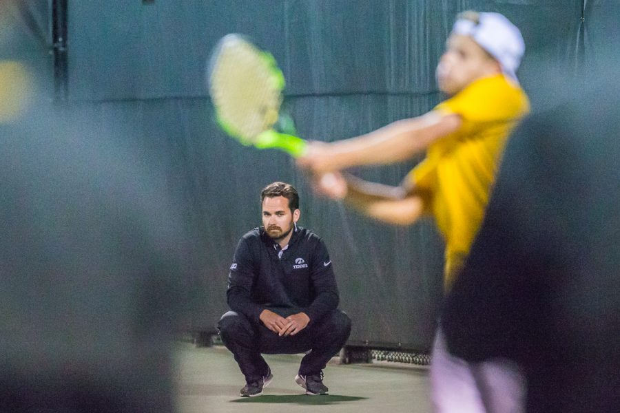 Iowa head coach Ross Wilson watches as Will Davies plays during a mens tennis match between Iowa and Michigan State at the HTRC on Friday, April 19, 2019. The Hawkeyes defeated the Spartans, 5-2.