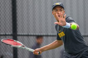 Iowas Oliver Okonkwo hits a forehand during a mens tennis match between Iowa and Ohio State at the HTRC on Sunday, April 7, 2019. The Buckeyes defeated the Hawkeyes, 4-1.