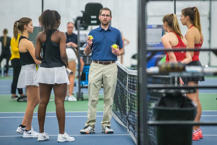 An official speaks with the 3-doubles teams before a women's tennis match between Iowa and Nebraska at the HTRC on Saturday, April 13, 2019. The Hawkeyes, celebrating senior day, fell to the Cornhuskers, 4-2.