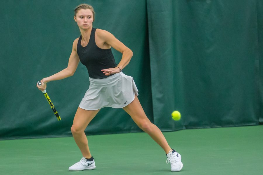 Iowa's Cloe Ruette hits a forehand during a women's tennis match between Iowa and Nebraska at the HTRC on Saturday, April 13, 2019. The Hawkeyes, celebrating senior day, fell to the Cornhuskers, 4-2.