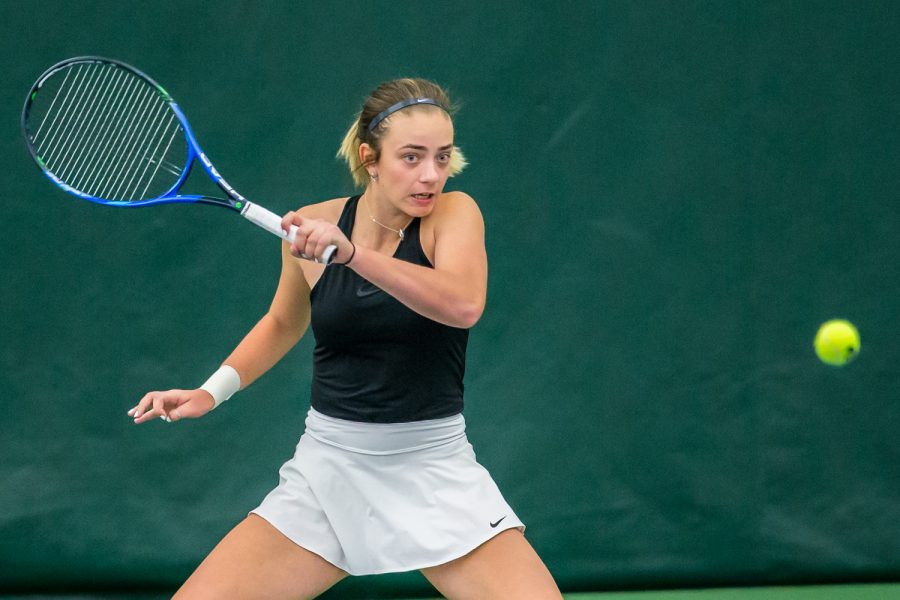 Iowa's Sophie Clark hits a forehand during a women's tennis match between Iowa and Nebraska at the HTRC on Saturday, April 13, 2019. The Hawkeyes, celebrating senior day, fell to the Cornhuskers, 4-2.