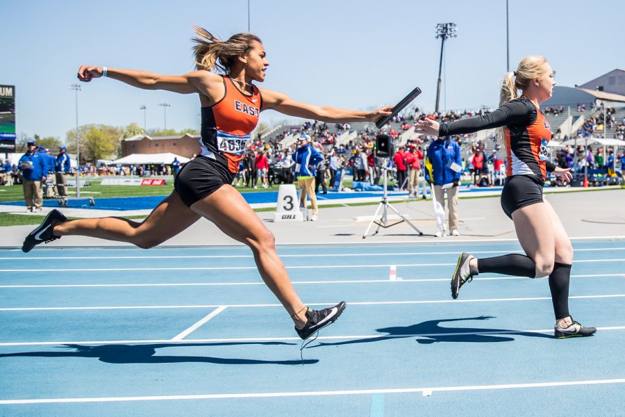 Sioux City East athletes exchange the baton during the girls' 4x200 race at the 2019 Drake Relays in Des Moines, IA, on Friday, April 26, 2019.