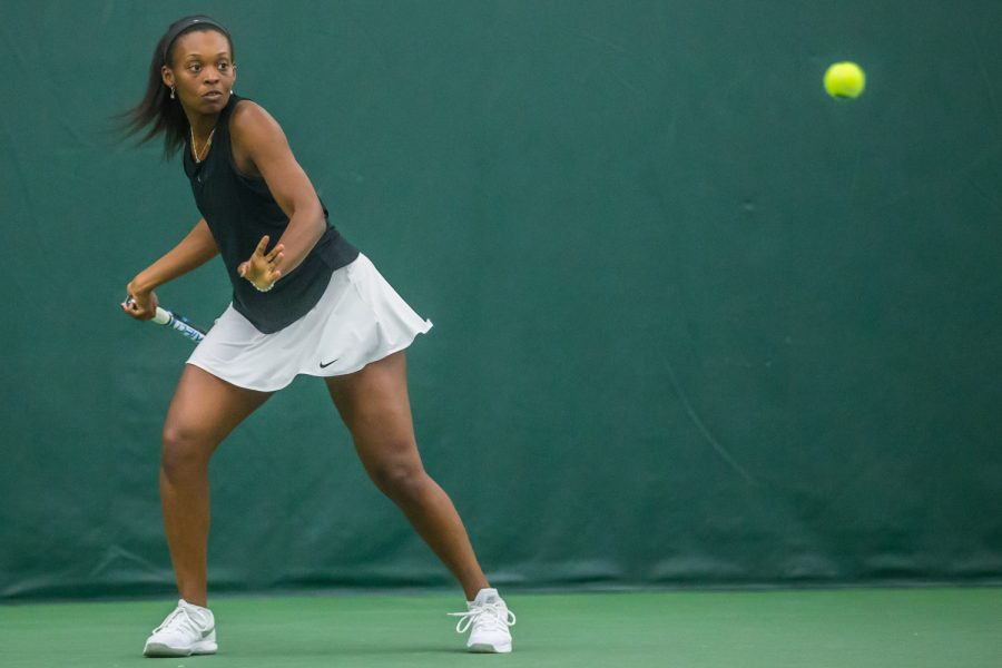 Iowa's Adorabol Huckleby hits a forehand during a women's tennis match between Iowa and Nebraska at the HTRC on Saturday, April 13, 2019. The Hawkeyes, celebrating senior day, fell to the Cornhuskers, 4-2.