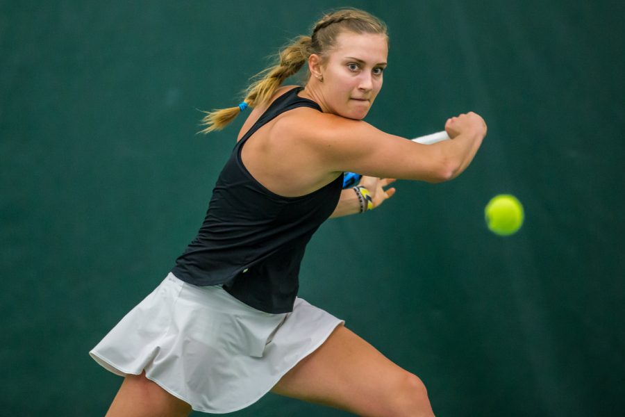 Iowa's Ashleigh Jacobs hits a backhand during a women's tennis match between Iowa and Nebraska at the HTRC on Saturday, April 13, 2019. The Hawkeyes, celebrating senior day, fell to the Cornhuskers, 4-2.