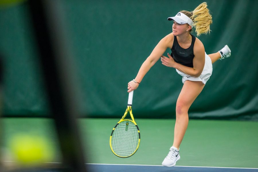 Iowa's Danielle Burich hits a serve during a women's tennis match between Iowa and Nebraska at the HTRC on Saturday, April 13, 2019. The Hawkeyes, celebrating senior day, fell to the Cornhuskers, 4-2.