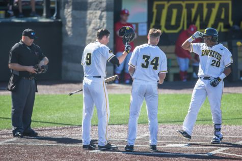 Iowa infielder Izaya Fullard (20) returns home after hitting a home run during a baseball game between Iowa and Nebraska at Duane Banks Field on Saturday, April 20, 2019. The Hawkeyes defeated the Cornhuskers, 17-9.
