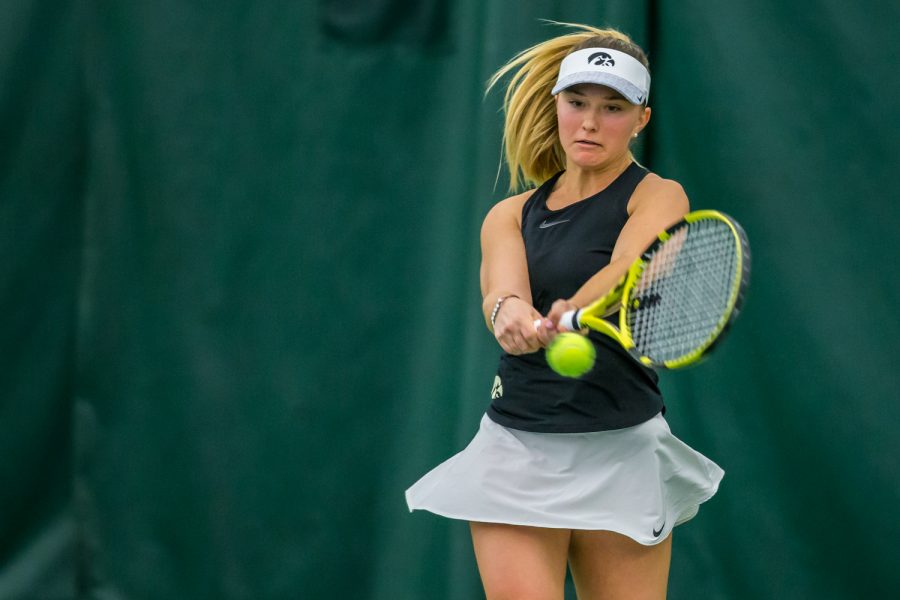 Iowa's Danielle Burich hits a backhand during a women's tennis match between Iowa and Nebraska at the HTRC on Saturday, April 13, 2019. The Hawkeyes, celebrating senior day, fell to the Cornhuskers, 4-2.