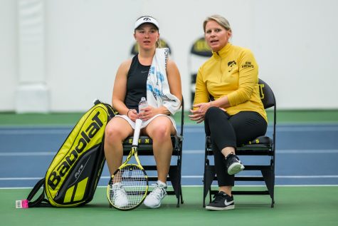 Iowa head coach Sasha Schmid (right) talks with Danielle Burich during a womens tennis match between Iowa and Nebraska at the HTRC on Saturday, April 13, 2019. The Hawkeyes, celebrating senior day, fell to the Cornhuskers, 4-2.