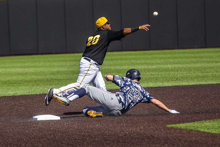 Iowa infielder Izaya Fullard throws the ball to first as UC Irvine infielder Brandon Lewis slides into the base during the game against UC Irvine at Duane Banks Field on Saturday, May 4, 2019. The Hawkeyes defeated the Anteaters 1-0.