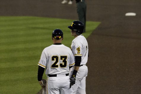 Iowa assistant coach Robin Lund gives infielder Brendan Sher advice on first base during the game against Michigan State at the Duane Banks Baseball Stadium on Friday, May 10, 2019. The Hawkeyes defeated the Spartans 7-5.