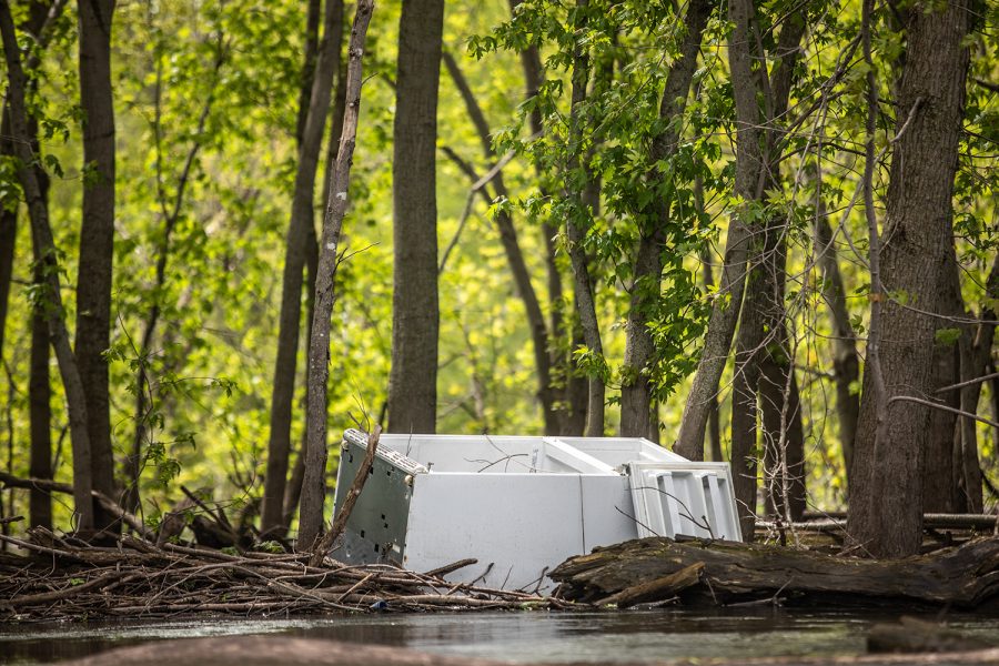 An abandoned fridge sits in a pile of logs along the river south of Whitetail Flats Wilderness Management Area on May 23, 2019. This was the second fridge photojournalist Ryan Adams saw on his paddle down the Iowa River. 